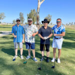 Photo of winning team on the golf course